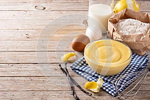 Pastry cream in a bowl and ingredients photo