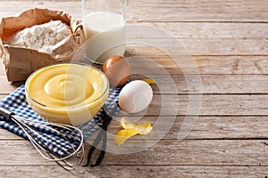 Pastry cream in a bowl and ingredients photo