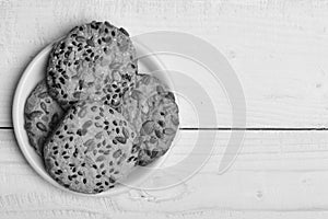 Pastry and homemade goods concept. Oatmeal cookies with seeds on white old wooden table