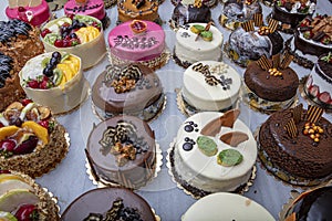 Pastry shop with selection of cream or fruit cake. Colorful beautiful cakes displayed on the marble countertop