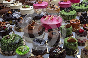 Pastry shop with selection of cream or fruit cake. Colorful beautiful cakes displayed on the marble countertop