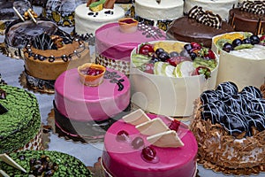 Pastry shop with selection of cream or fruit cake. Colorful beautiful cakes displayed on the marble countertop