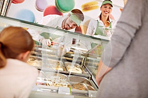 In pastry store sellers serves customers