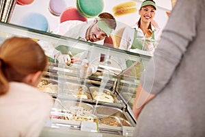 In pastry store sellers serves customers photo