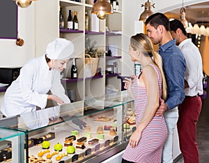 Pastry woman is serving visitors