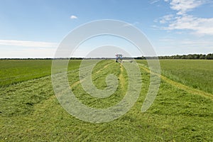 Pasture mowing with blue tractor