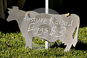 Pasture raised egg sign on a cow chalkboard at a farmers market