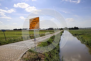 Pastures with farms and roads in the future Fifth Village of the Zuidplaspolder of the municipality of Zuidplas