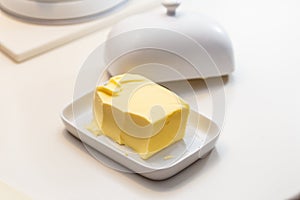 Pat of farm butter in a ceramic butter dish