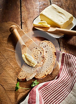 Pat of farm butter with slices of rye bread