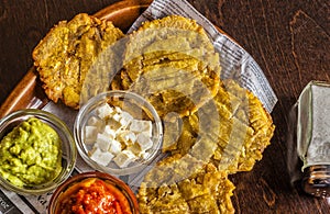 Patacones or tostones are fried green plantain slices photo