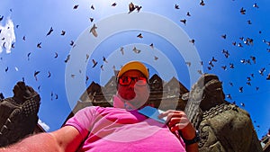 PATAN, NEPAL - April 13, 2018: Man making selfie against tample in Patan, ancient city in Kathmandu Valley.