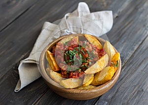 Patatas Bravas, baked potatoes with spicy tomato sauce photo