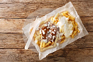 Patatje oorlog is a Dutch street food dish consisting of fries topped with a mayonnaise, finely chopped onions and peanut sauce