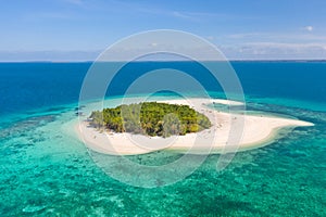 Patawan island. Small tropical island with white sandy beach. Beautiful island on the atoll, view from above