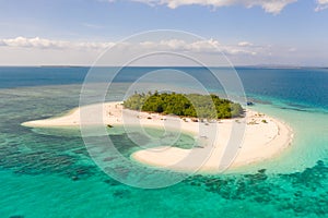 Patawan island. Small tropical island with white sandy beach. Beautiful island on the atoll, view from above