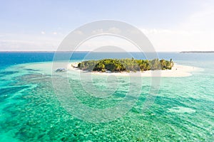 Patawan island. Small tropical island with white sandy beach. Beautiful island on the atoll, view from above