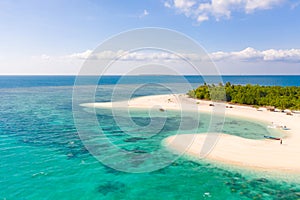 Patawan island. Small tropical island with white sandy beach. Beautiful island on the atoll, view from above