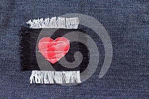 Patch with red heart on the jeans fabric