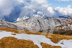 Patches of snow building up on slopes of Snowy Mountains at Mount Kosciuszko National Park, Australia