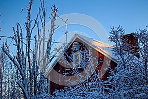 Patches of sunlight on Swedish house in winter