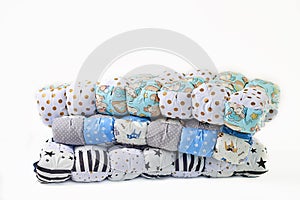 Patchwork and fashion concept - beautiful stack of colorful quilts, bedspreads stacked in several rows in height for storage, sale