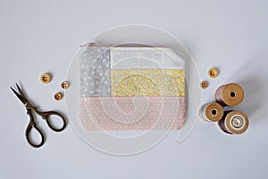 Patchwork mini pouch, wooden buttons, vintage thread spools and retro scissors