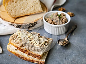 Pate of fish with mackerel, nuts, sour cream with homemade bread on gray background. Healthy breakfast, lunch, snack