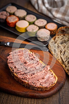 Pate on a slice of bread on wooden table