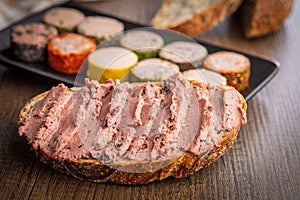Pate on a slice of bread on wooden table