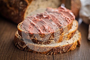 Pate on a slice of bread on wooden table