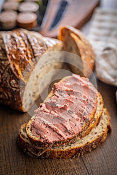Pate on a slice of bread on wooden table