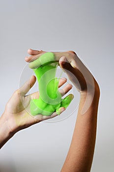 Pate slime elastic and viscous on child`s hand photo