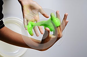 Pate slime elastic and viscous on child`s hand photo