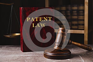 Patent Law book and gavel on grey marble table