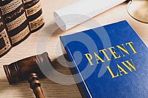 Patent Law book and gavel on wooden table