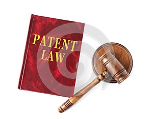 Patent Law book and wooden gavel on white background, top view