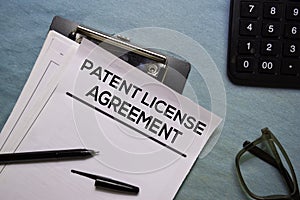 Patent Licence Agreement text on Document form  on office desk.