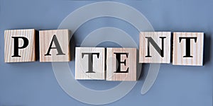 PATENT - word on wooden cubes on a gray background