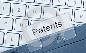 Patents - folder with text on computer keyboard