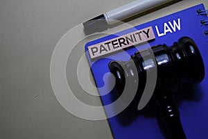 Paternity Law text on sticky notes and gavel isolated on office desk. Justice law concept photo