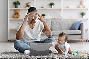 Paternity Leave Stress. Black Father Having Problems With Remote Work While Babysitting photo