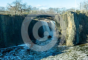 Landscape view of the Great Falls of the Passaic River. A prominent waterfall, 77 feet high, on