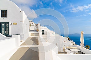 Path in beautiful Firostefani village with typical white architecture, Santorini island, Greece