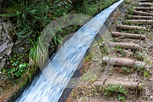 The path by beautiful irrigation canal named levadas in Madeira island