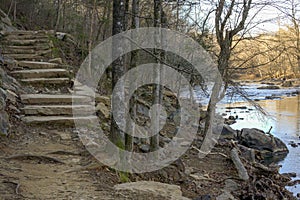 A Path Follows a River and Winds up Stone Stairs.