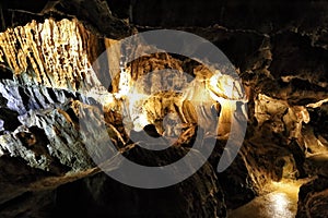 Path inside cave with stone ornaments and cracked walls