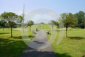 Path in lawn to slope in playground on sunny summer day