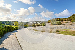 A path leads to the ancient Pont du Gard Roman Aqueduct over the River Gardon in the Provence area of France.