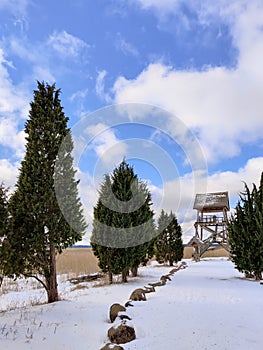 Path leads to the bird watching tower. Wooden observation tower stands in the national park. Outdoor adventure